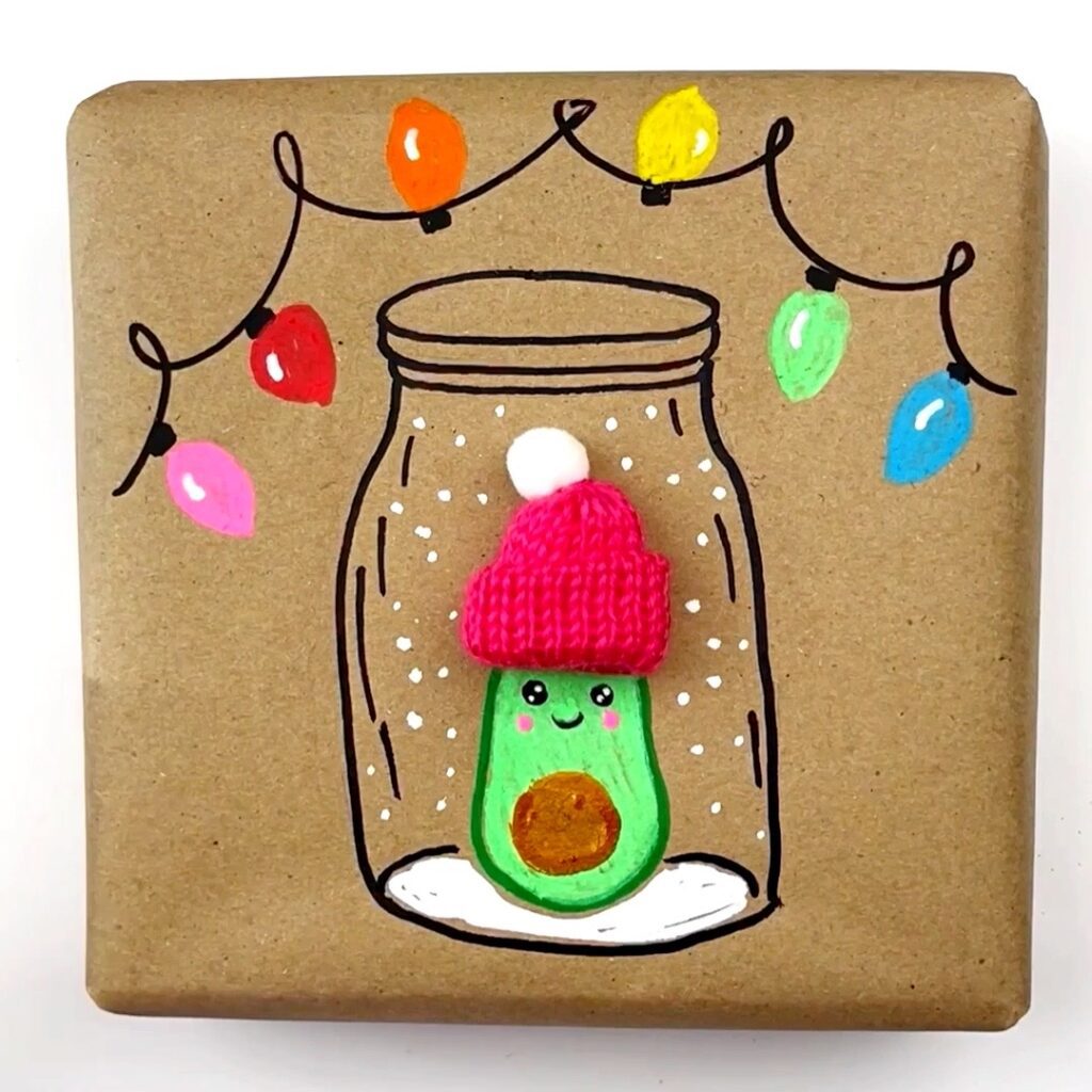 DIY Festive Wrapping Paper Avocado drawing is done and it is wearing a glued on knit hat