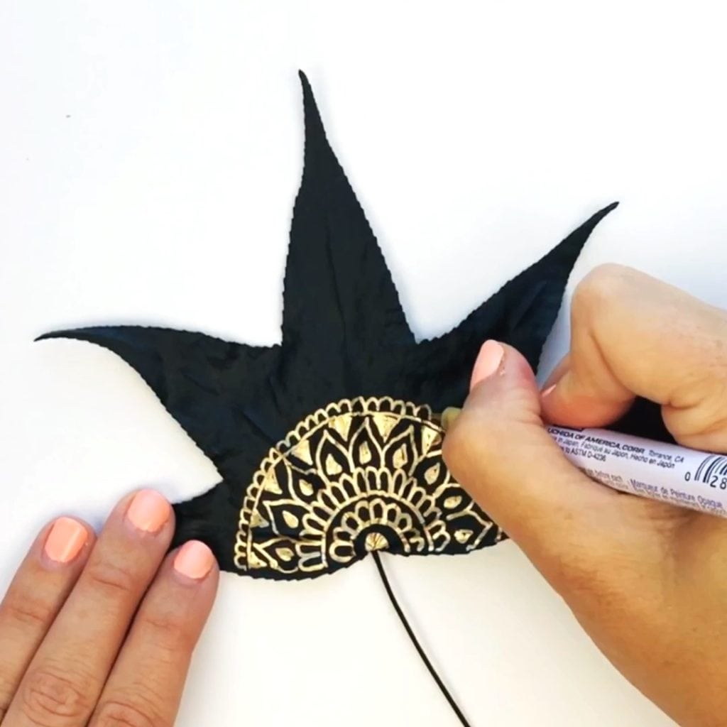 Drawing a mandala design with gold