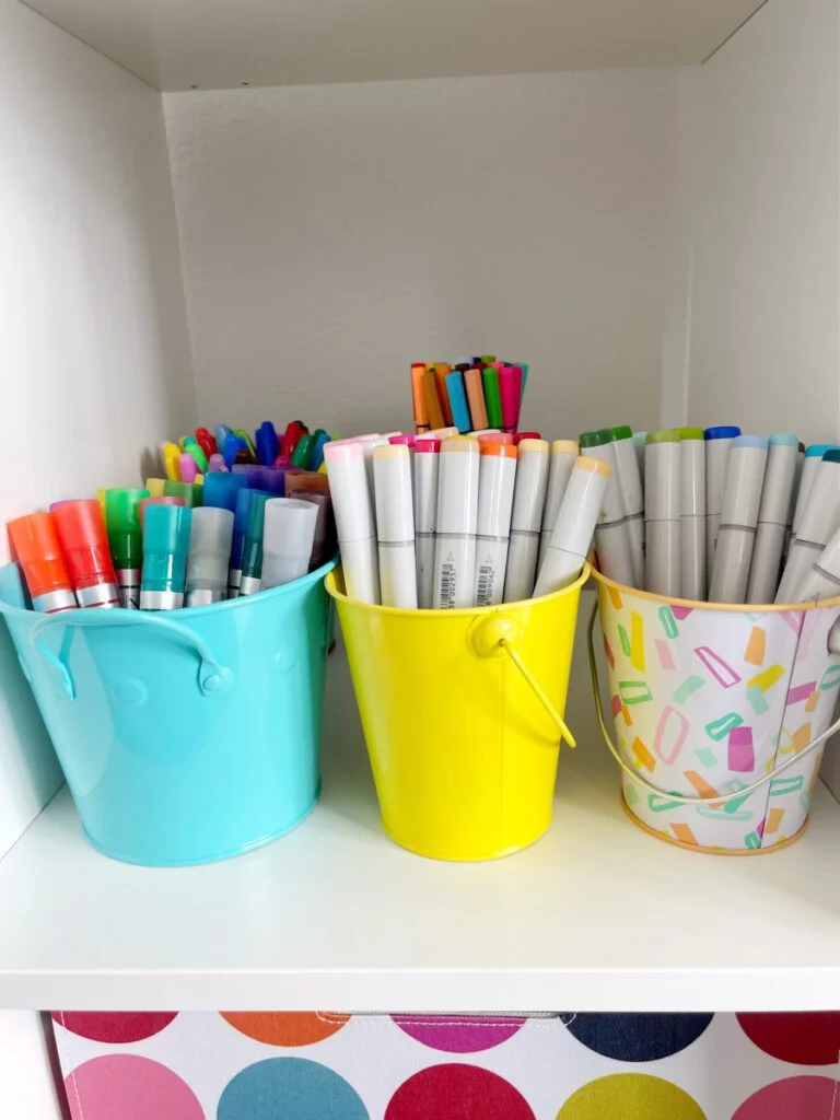 Using metal pails to organize pens in a crafting space